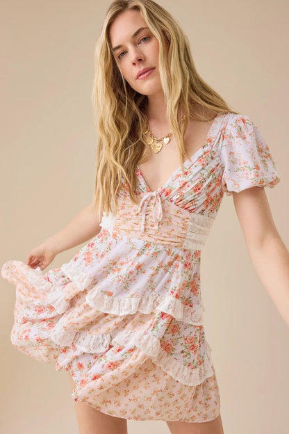 Minijurk met bloemmotief, kanten patchwork, V-hals en pofmouwen