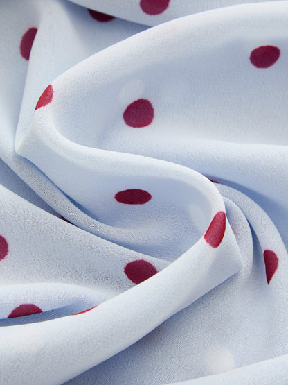 Detail van patchwork polkadot print op de midi slipdress